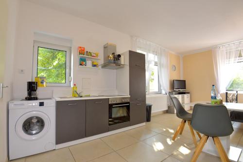 a kitchen with a washing machine and a washer at Parkvilla Köhler in Zella-Mehlis