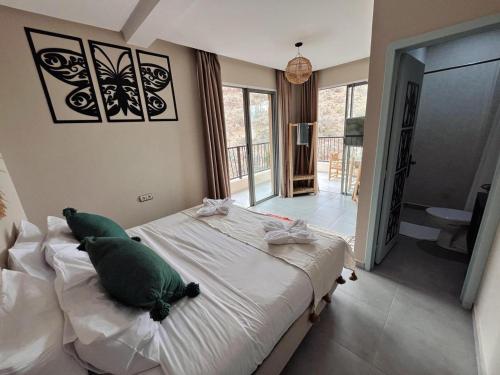 a bedroom with a bed with a green pillow on it at harmony surf lodge in Taghazout
