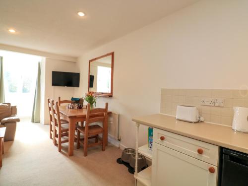 a kitchen and dining room with a table and chairs at Millers Loft in Ivybridge
