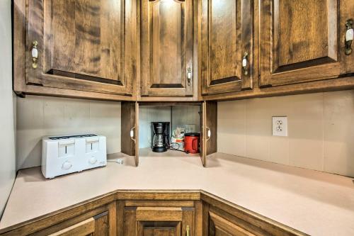 a kitchen with wooden cabinets and a microwave at Creek Access and Deck Runningwater Lancaster Gem in Lancaster