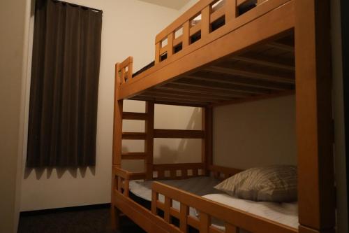 a bedroom with two bunk beds in a room at Guesthouse Sign in Kyoto