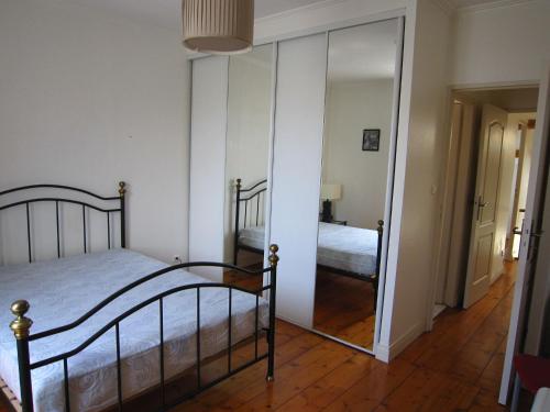 a bedroom with a bed and a large mirror at Charming 100m2 House in Croix-Chapeau, 15mn from La Rochelle in Croix-Chapeau