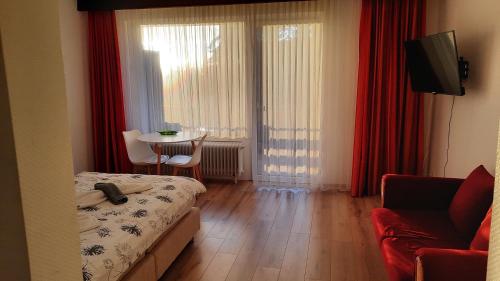 a room with a bed and a table with a chair at Naturkost-Hotel Harz in Bad Grund