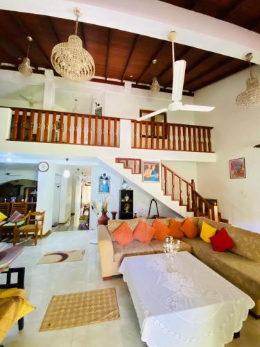 a living room with a couch and a table at New King well resort and guest house in Ahangama