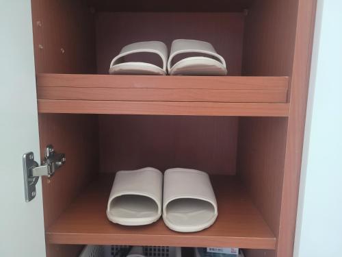 a cupboard with two plates and an open book at With Hongdae in Seoul