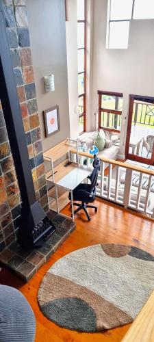 a living room with a fireplace and a couch at Peak's Cabin - Endless Ocean Views - Fireplace - Fast WiFi in Wilderness