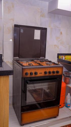 a stove top oven sitting in a kitchen at KYM'S Superstays in Meru