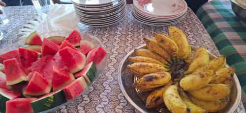 two plates of fruit sitting on a table at Supipi House Panama in Panama