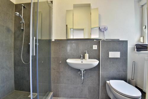 a bathroom with a sink and a toilet and a shower at Parkvilla Köhler in Zella-Mehlis