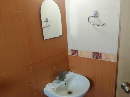 a bathroom with a sink and a mirror at SHIVANGAN HOTEL and BANQUET in kolkata