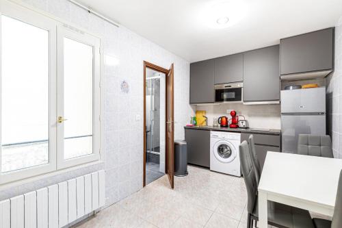 une cuisine avec laveuse et sécheuse dans l'établissement GuestReady - Peaceful Retreat in Canal St Martin, à Paris