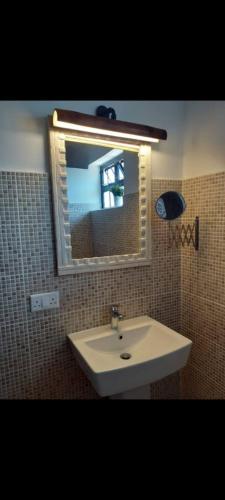 a bathroom with a sink and a mirror at Villa CasaGrande in Ukunda Airport