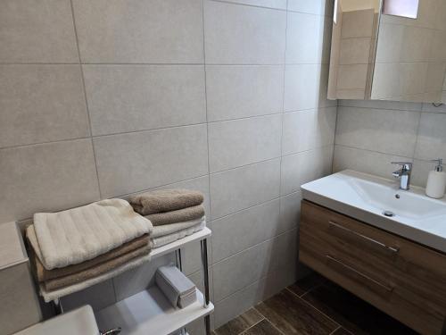 a bathroom with a sink and a toilet and a mirror at Penzión Pegas in Bratislava