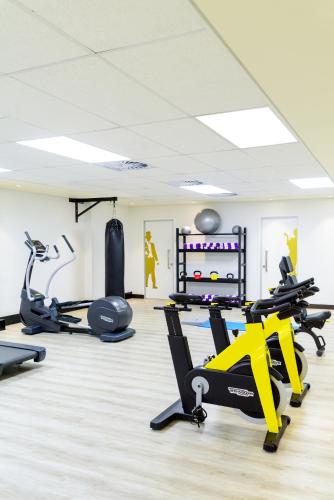 a gym with treadmills and elliptical machines at Hotel Sky Sandton in Johannesburg