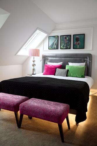 En eller flere senge i et værelse på Absalon Hotel