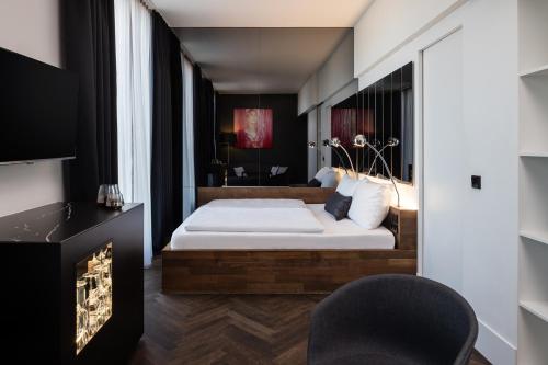 a bedroom with a bed and a fireplace at Hotel AMANO Grand Central in Berlin