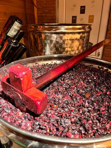 a stick of red candy in a pan of candy at Winery & Brewery - Family Guesthouse "Villa Rbona" in Khashuri