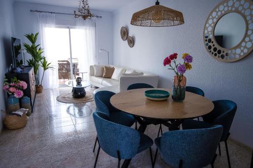 a living room with a table and blue chairs at Rd02 La Casa Hermosa in Torrox