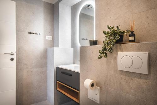 a bathroom with a sink and a mirror at D&A Central Luxury Apartments with FREE Parking in Pula