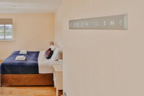 a bedroom with a bed and a sign that readsupper line at Rock Farm Slane - Limehouse in Slane
