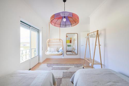 a bedroom with a bed and a ladder and a mirror at Vieira beach house apartment with sea view in Vieira de Leiria