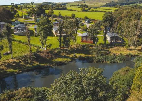 an aerial view of a village with a river at Docker Holiday Park in Carnforth