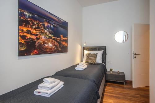 a bedroom with a bed with towels on it at D&A Central Luxury Apartments with FREE Parking in Pula