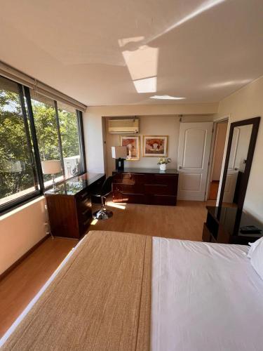a large room with a bed and a large window at II Orly Suites Pedro de Valdivia 0200 in Santiago