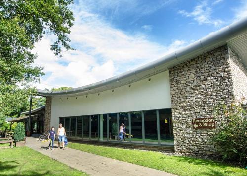 a building with people walking in front of it at Fell End in Milnthorpe