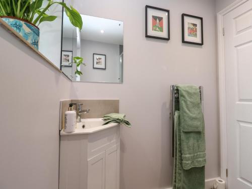 a bathroom with a sink and a mirror at Elder Cottage Studio in Truro