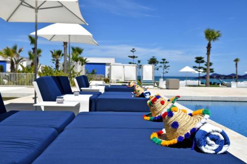a row of tables and chairs next to a pool at Sofitel Tamuda Bay Beach And Spa in M'diq