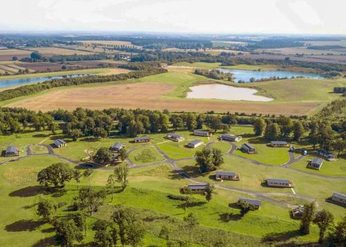 an aerial view of a park with a lake at Aspen Lodge Escape in Hengrave