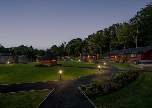 a garden with lodges and lights at night at Gadgirth Estate Lodges in Annbank