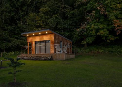 a small cabin with a deck in a yard at Gadgirth Estate Lodges in Annbank