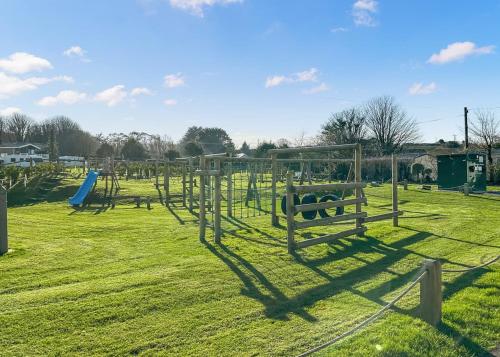a park with a playground with a slide at Hamlet Lodge Retreat At Calloose Holiday Park in Hayle