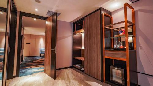 a hallway with a door leading into a room at FUGO Hotel Samarinda in Samarinda