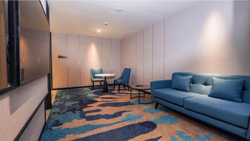a living room with a couch and a table at FUGO Hotel Samarinda in Samarinda