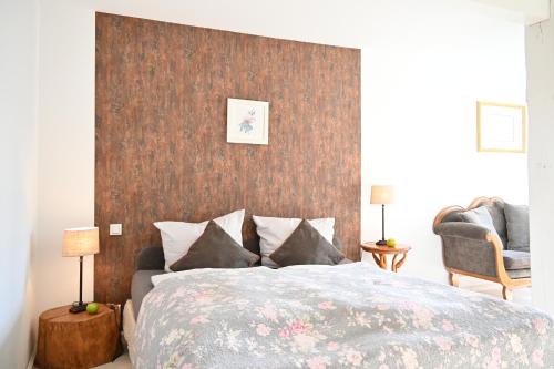 a bedroom with a large bed with a brown wall at Landsitzhotel und Seminarium Peterhof in Hodorf