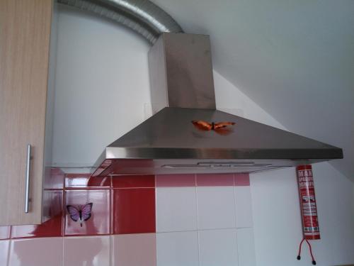 two butterflies sitting on top of a stove top oven at Lisbon Coast Flat in Quinta de Santo António