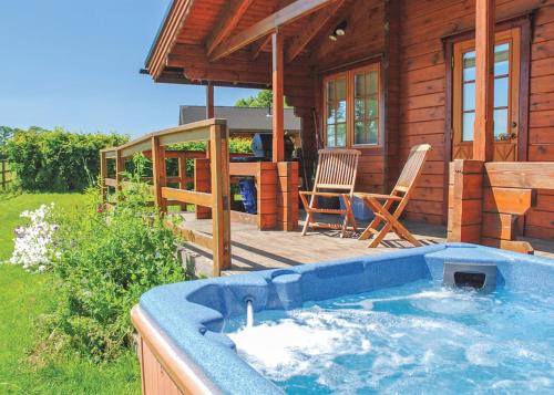 a large hot tub in front of a log cabin at Home Farm in Stillingfleet
