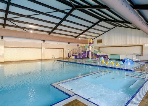 a large indoor swimming pool with a water park at Ladram Bay Holiday Park in Otterton