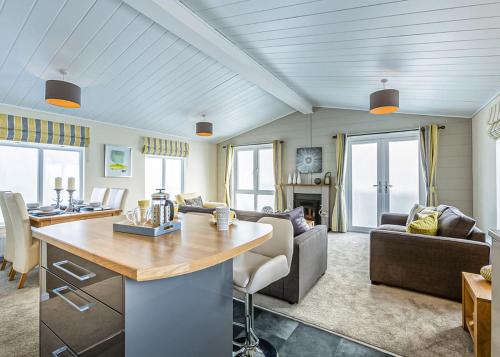 a kitchen and living room with a couch and a table at Kings Lynn Holiday Park in King's Lynn