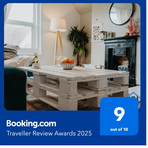 a living room with a wooden coffee table at Indigo Snug - Gorgeous 2 bed flat in the heart of Cromer in Cromer