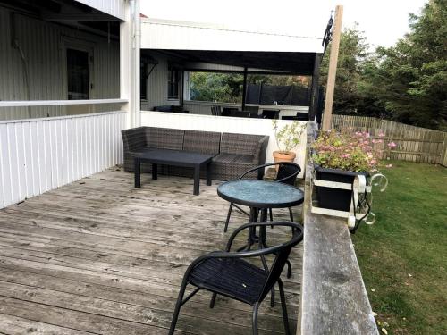a patio with two chairs and a table and a bench at Mellbystrand in Mellbystrand