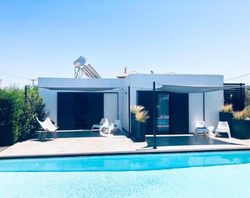 a house with a swimming pool next to a house at Soulbreeze Bungalows Kos, Haus 4 in Platánion