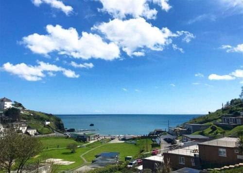 a view of a beach with the ocean in the background at Millendreath Beach Resort in Looe