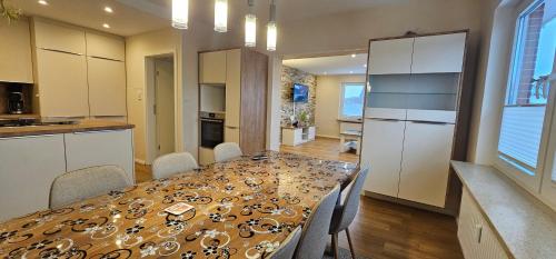 a kitchen and dining room with a table and chairs at Pension Sonnenstrand in Norden