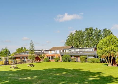 a building with picnic tables in a park at North Shore Holiday Park in Winthorpe