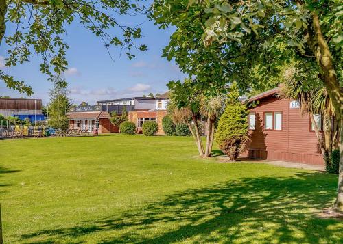 a house with a yard with green grass at North Shore Holiday Park in Winthorpe