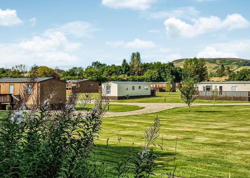a park with buildings and a grass field at Nethercraig Holiday Park in Alyth